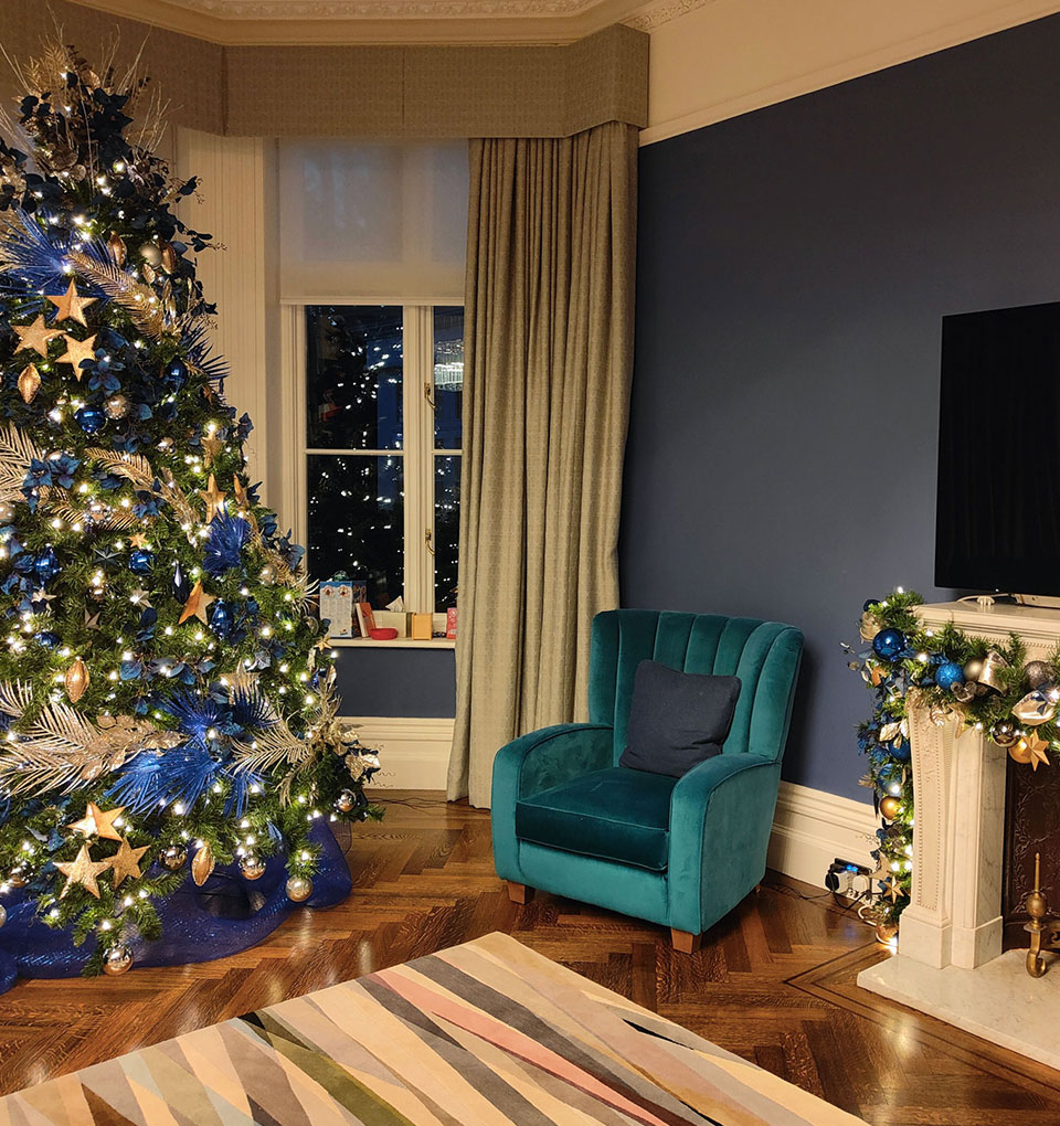 Blue and gold 9ft artificial Christmas tree and matching fireplace garland.