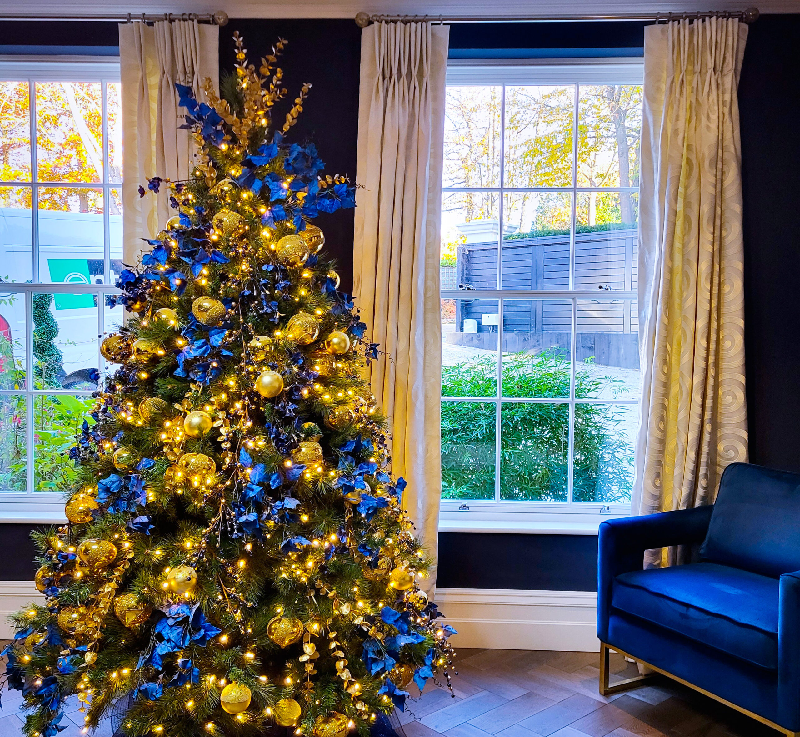 Blue and gold Christmas tree installed in a high end home in Surrey.