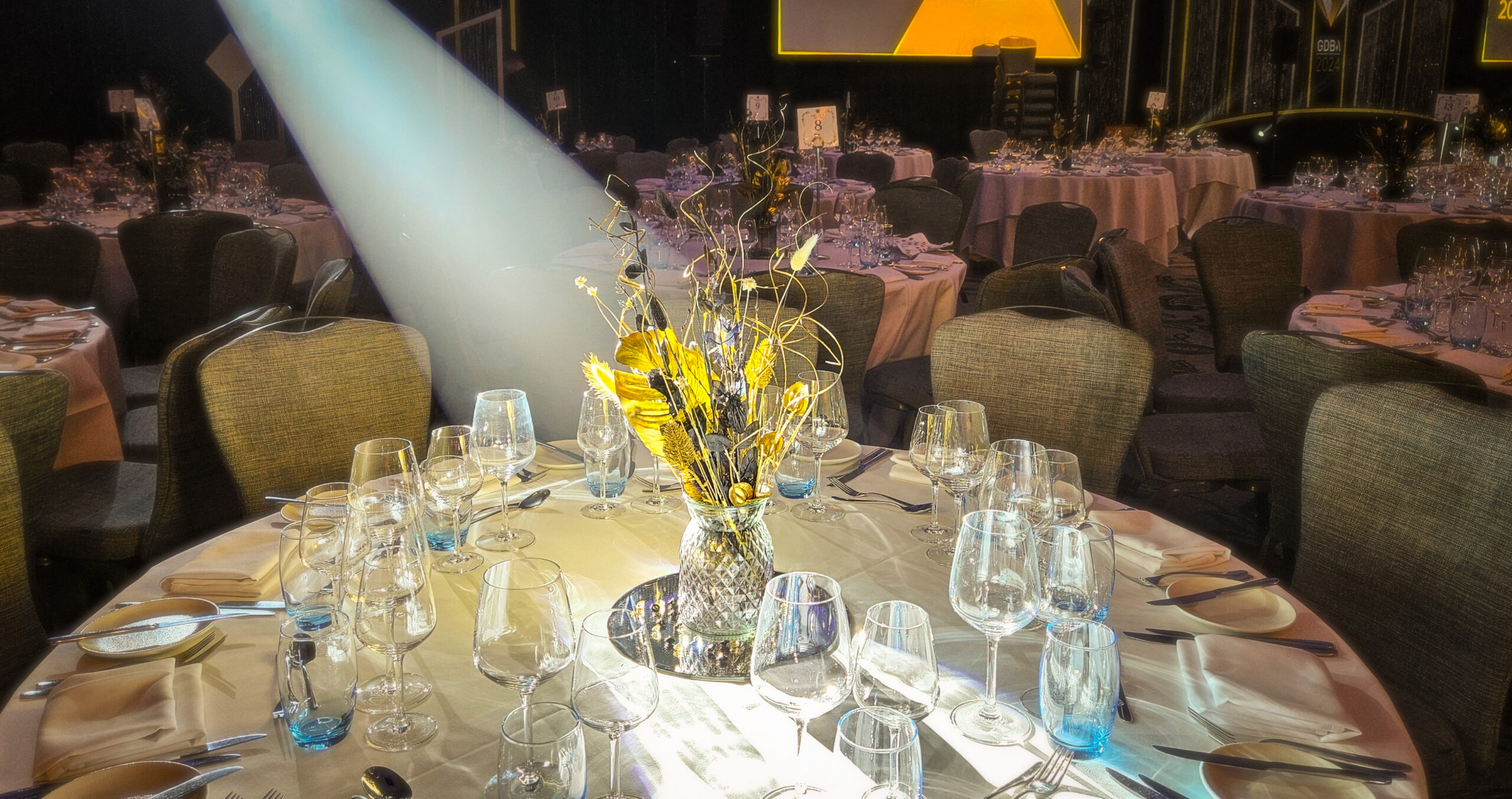 Black and gold awards ceremony table decorations.