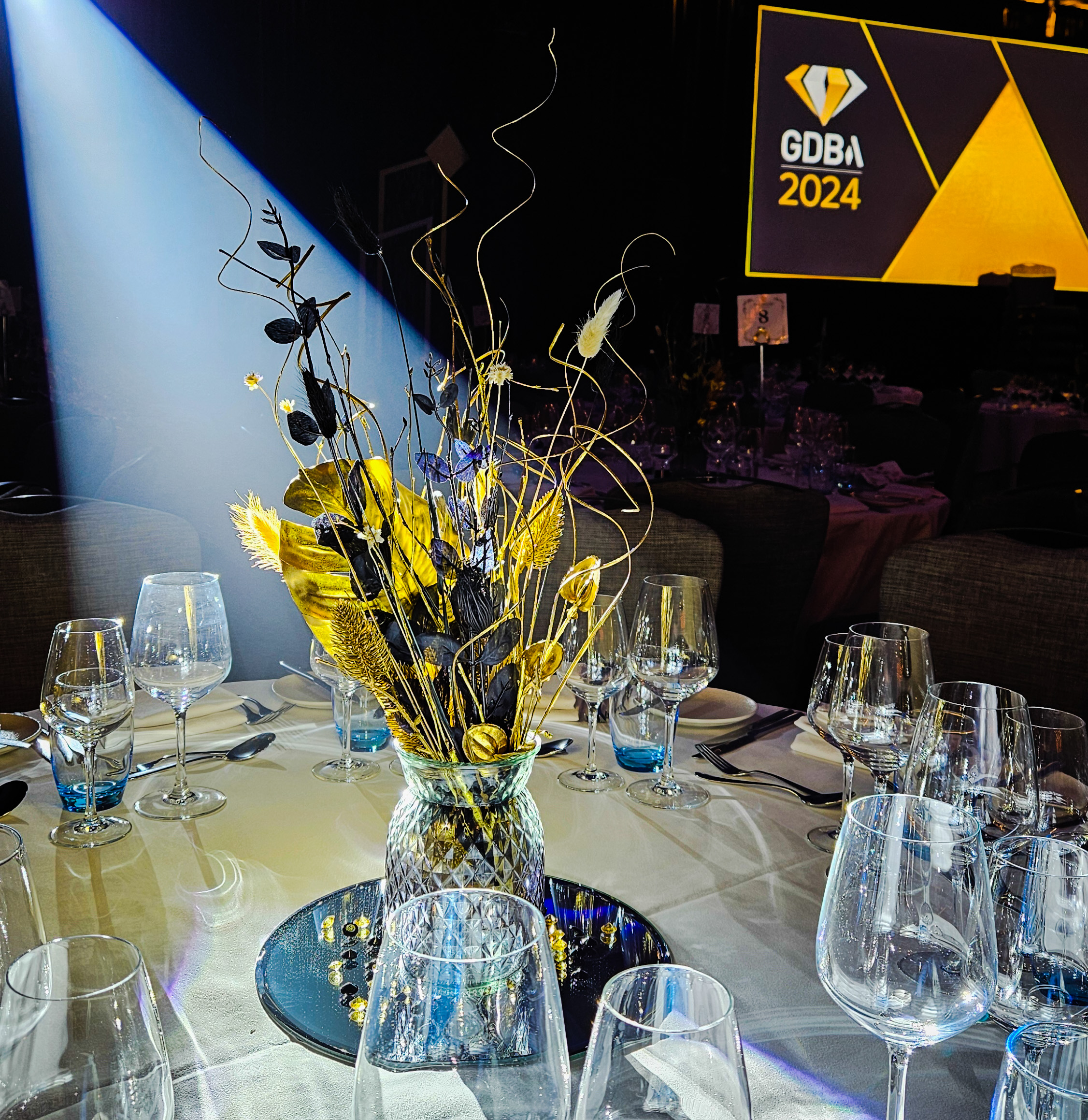 Black and gold table centrepiece for awards ceremony in Sussex.