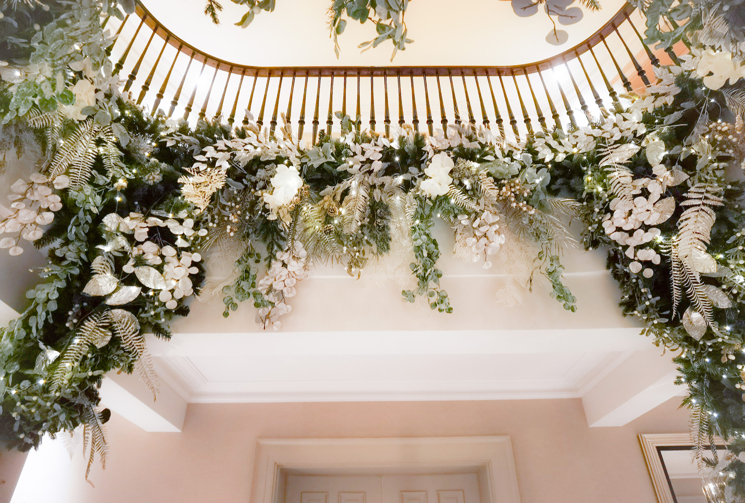 Foliage garlands with warm white fairy lights decorating a Surrey home.