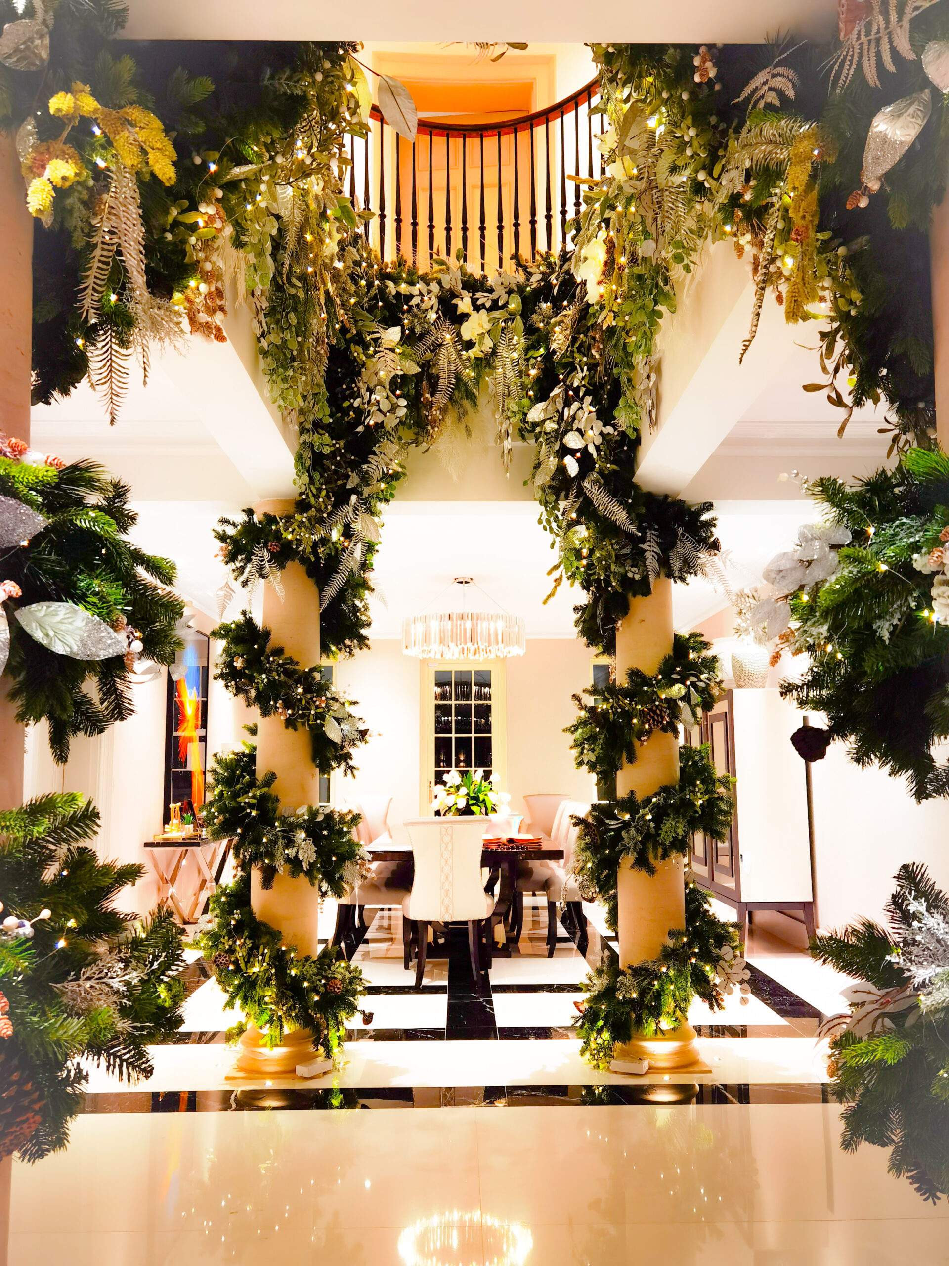 Green garlands with silver and white accents and warm white lights for a Surrey property.