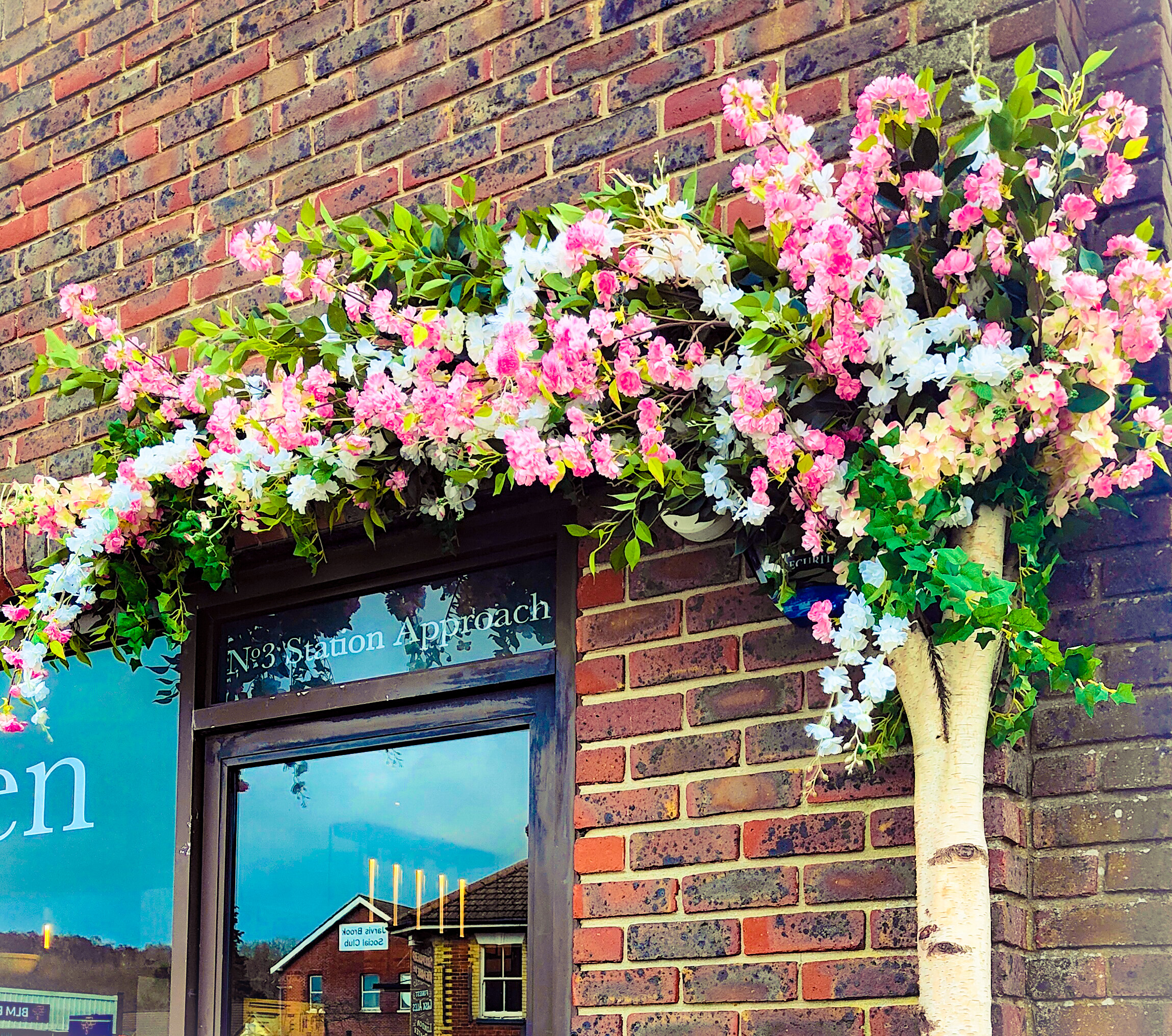 Pink blossom doorscape display for bespoke home design company in Sussex.