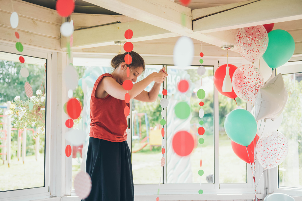 Young Noble and Whyte Decorator prepare strings and garlands for summer party.